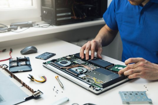 man fixing laptop man fixing laptop